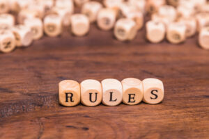 The word Rules written in wooden cubes